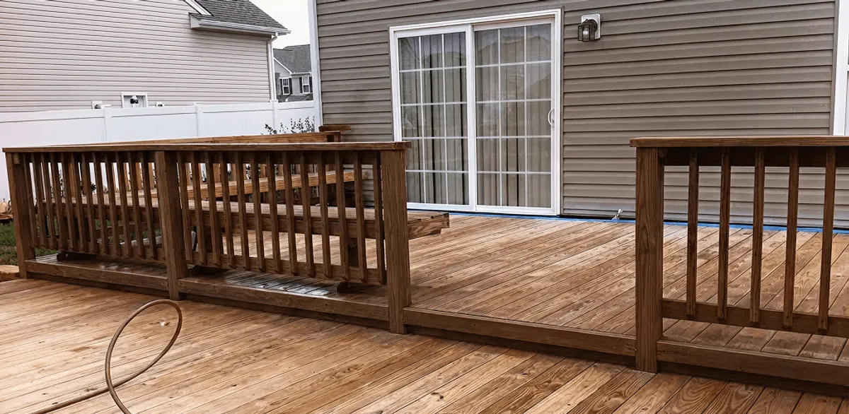 Deck sealing service protecting a backyard wood deck and railings in South Bend, IN