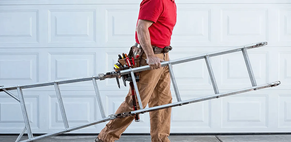 Garage door repair technician arriving with tools and ladder in South Bend, IN