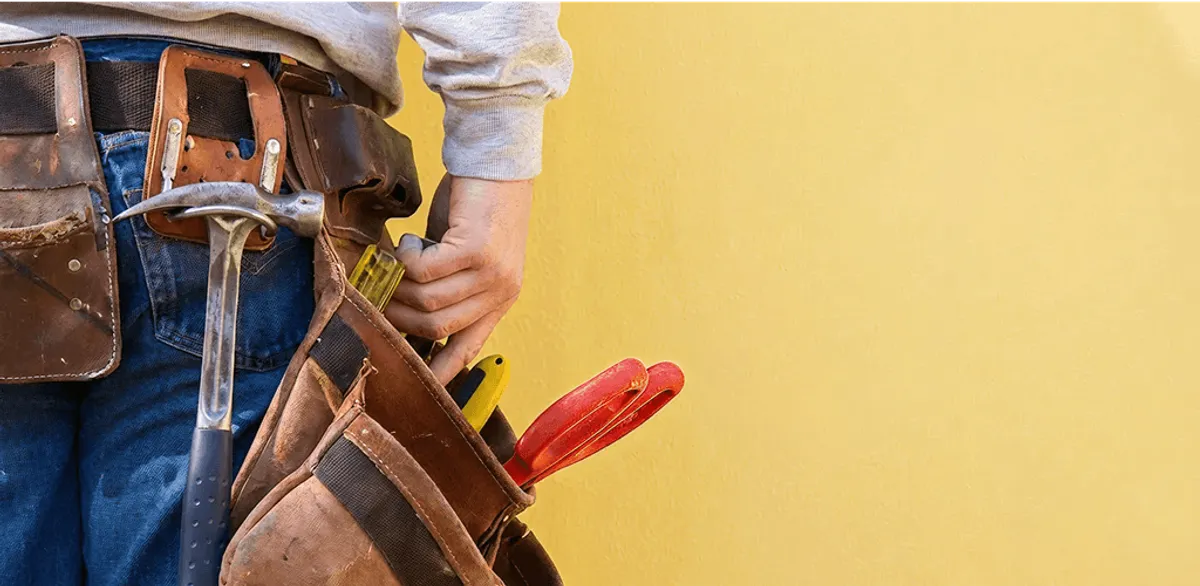 Handyman with tool belt ready for home repairs and maintenance in South Bend, IN