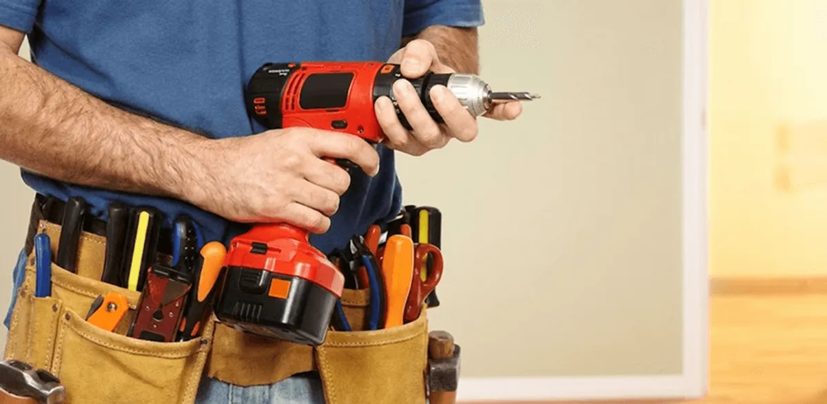 Handyman holding a power drill for home repairs and installations in South Bend, IN
