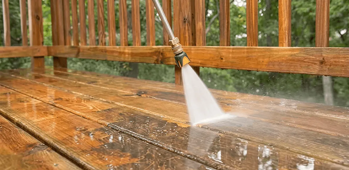 Pressure washing a wood deck to remove dirt and buildup in South Bend, IN