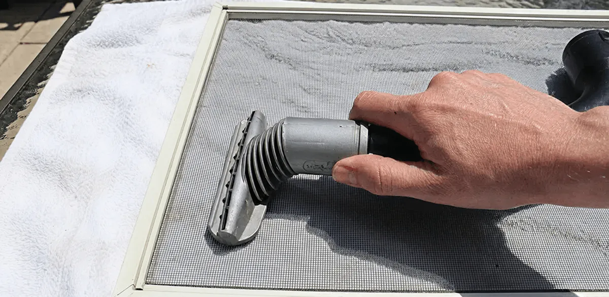 Window screen repair cleaning and fixing a damaged screen mesh in South Bend, IN